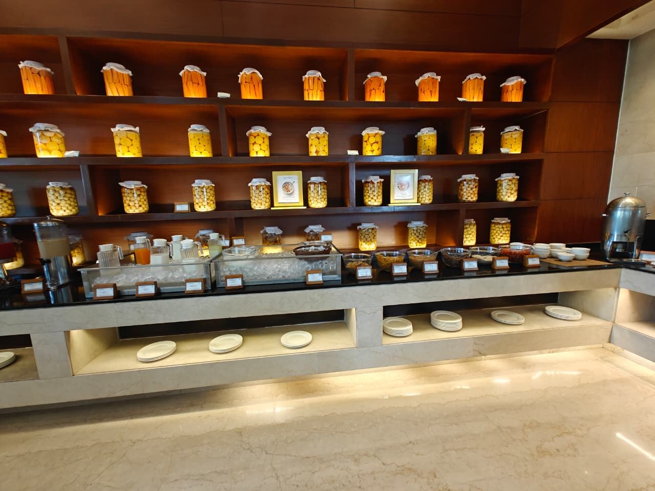 A wall of pickle and preserve jars behind the breakfast station