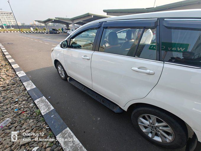 A white Innova Crysta from Avis waiting at Kochi airport