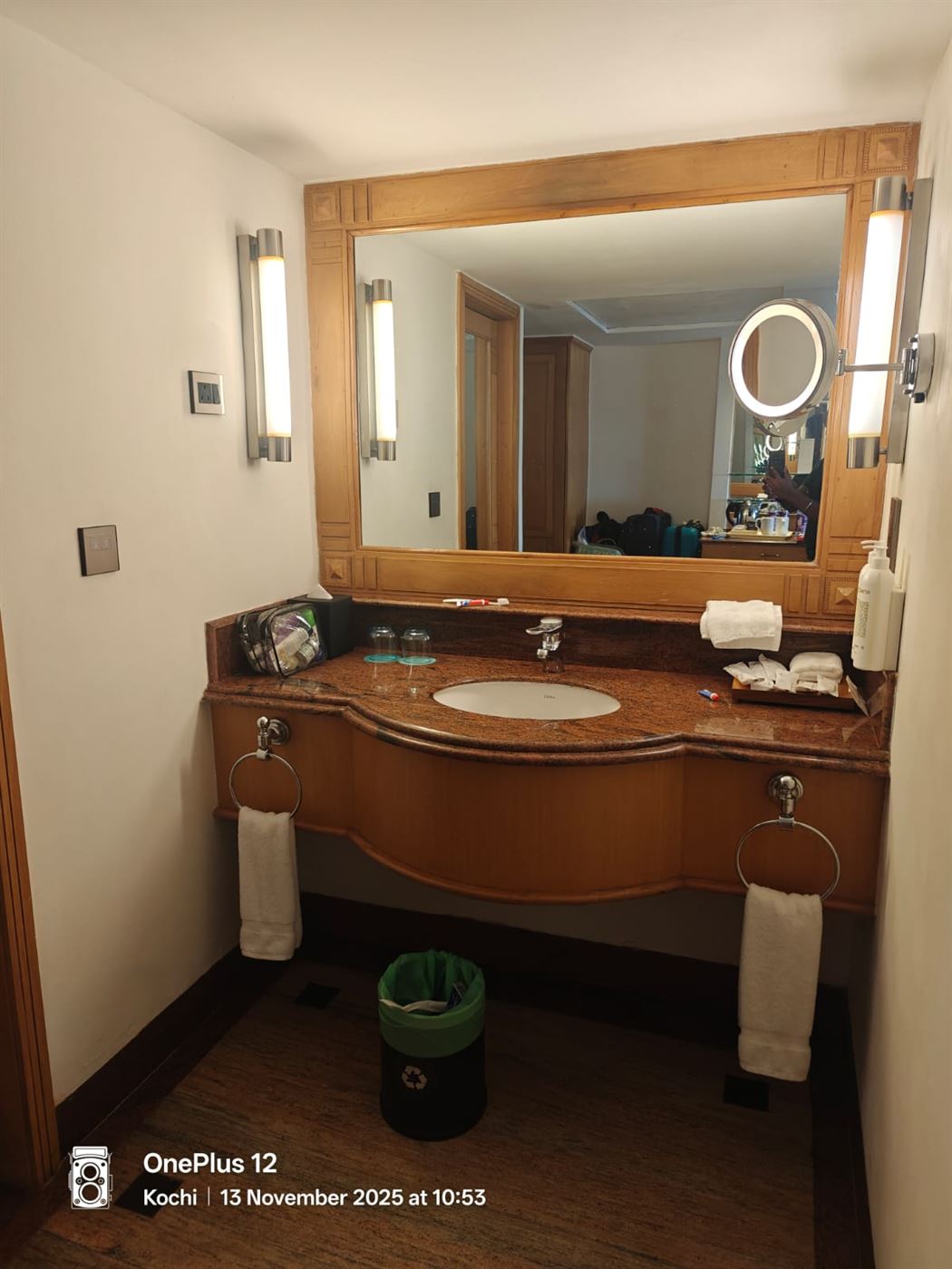 The room's granite-and-wood bathroom vanity with a large mirror