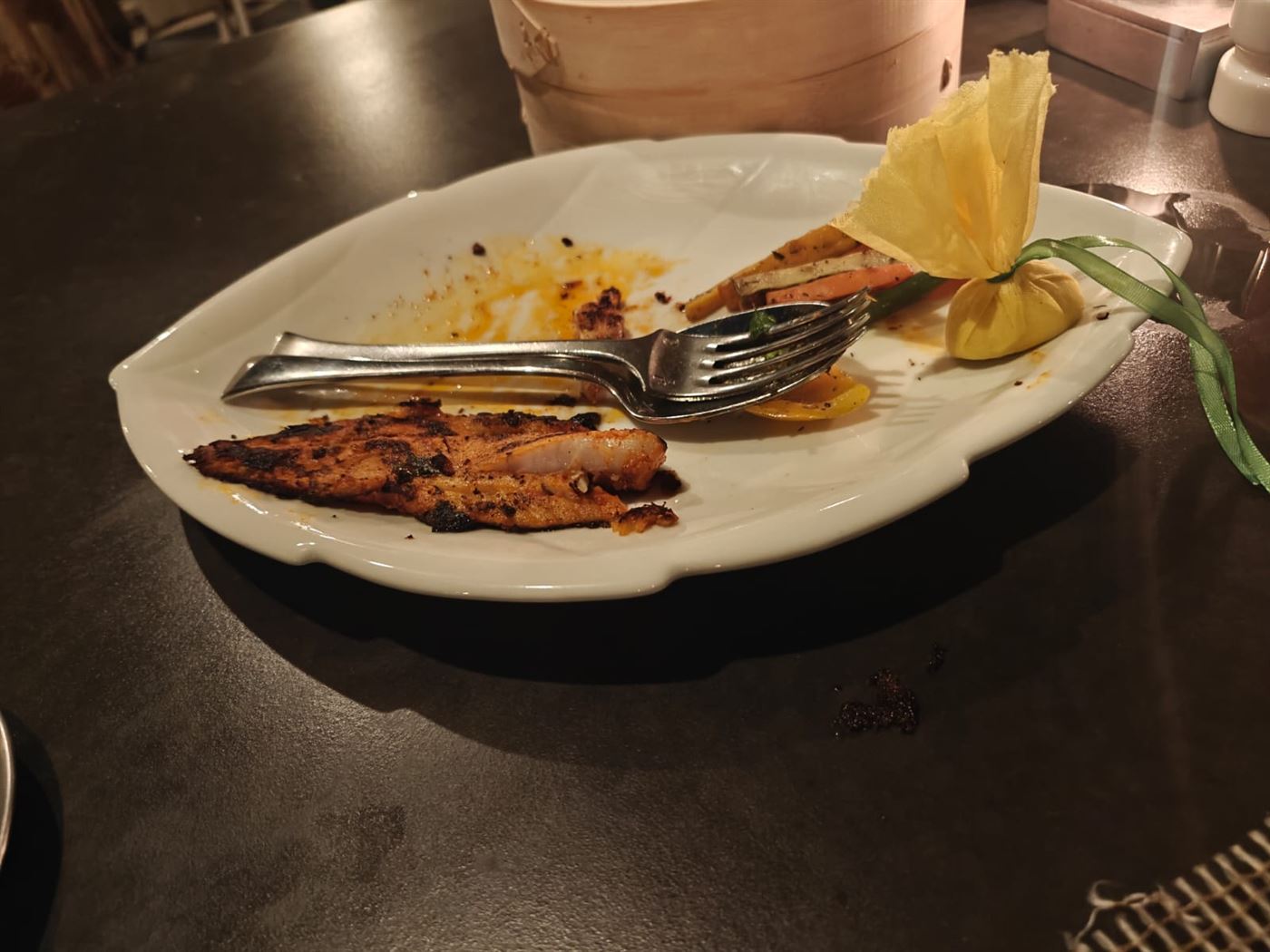 A plate of grilled fish with vegetables